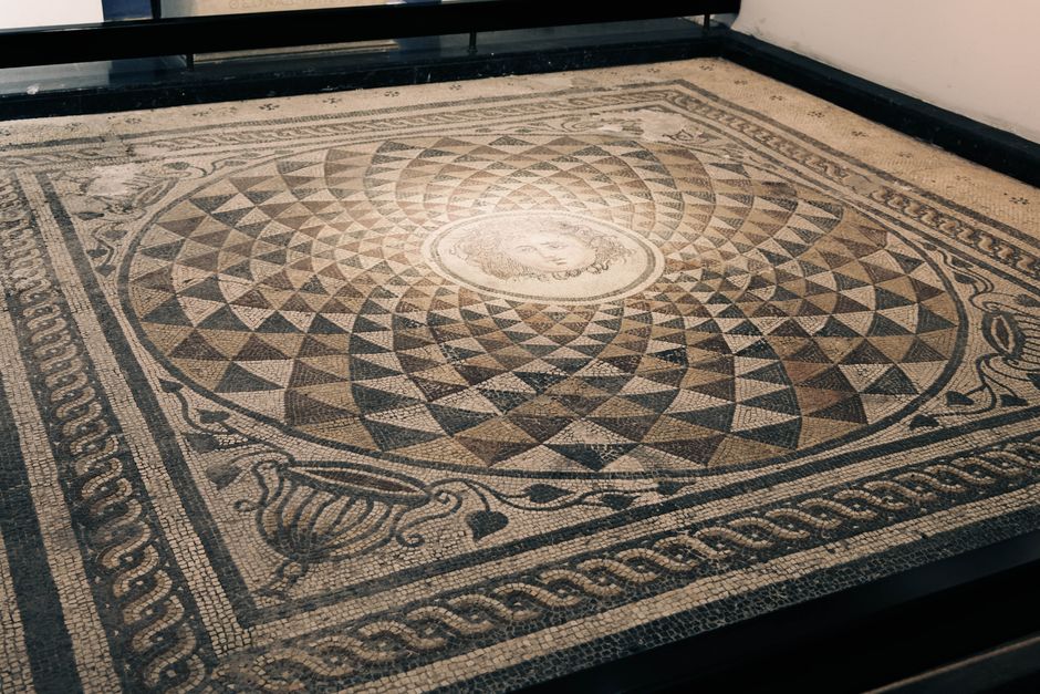 Explore a detailed ancient mosaic with geometric patterns at Bergama, İzmir.